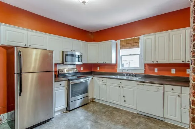 a kitchen with stainless steel appliances granite countertop a refrigerator sink and cabinets