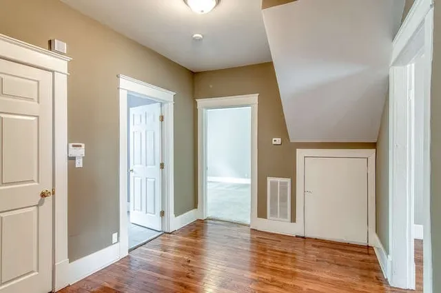 a view of a hallway with wooden floor