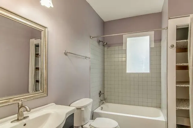 a bathroom with a sink mirror toilet and bathtub