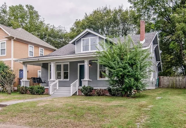 a front view of a house with a garden and porch