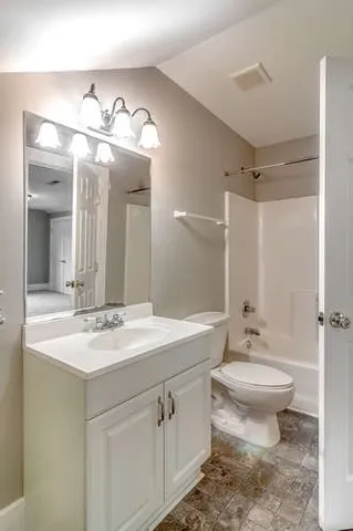 a bathroom with a sink a light fixture and a mirror