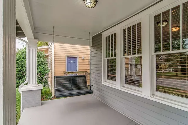 a view of porch with a chair and a fireplace