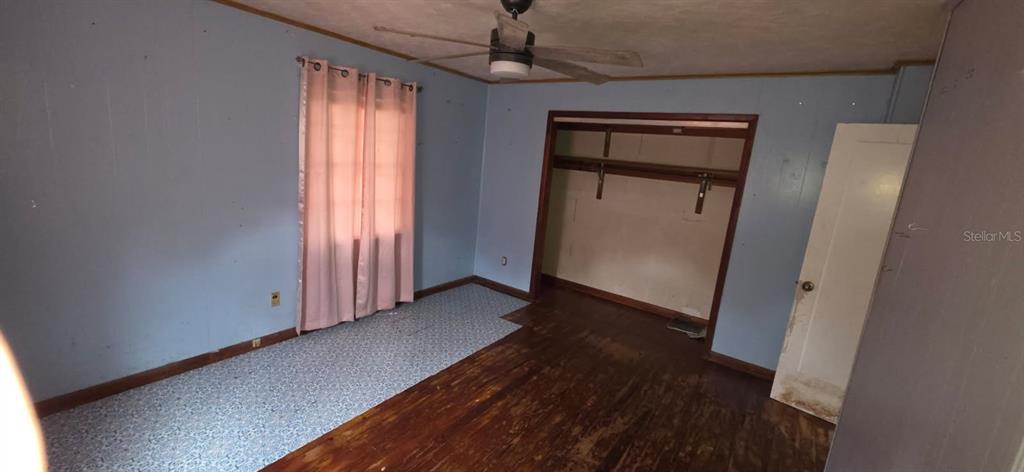 305 16th Avenue Ocoee, FL 34761 - Photo 14 of 20 a view of a hallway with wooden floor and closet area