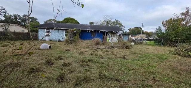 a view of a house with a yard and sitting area