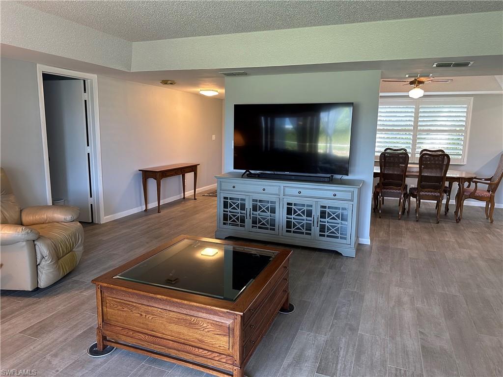 231 Memory Lane, Unit 3 Naples, FL 34112 - Photo 12 of 27 a living room with furniture and a flat screen tv