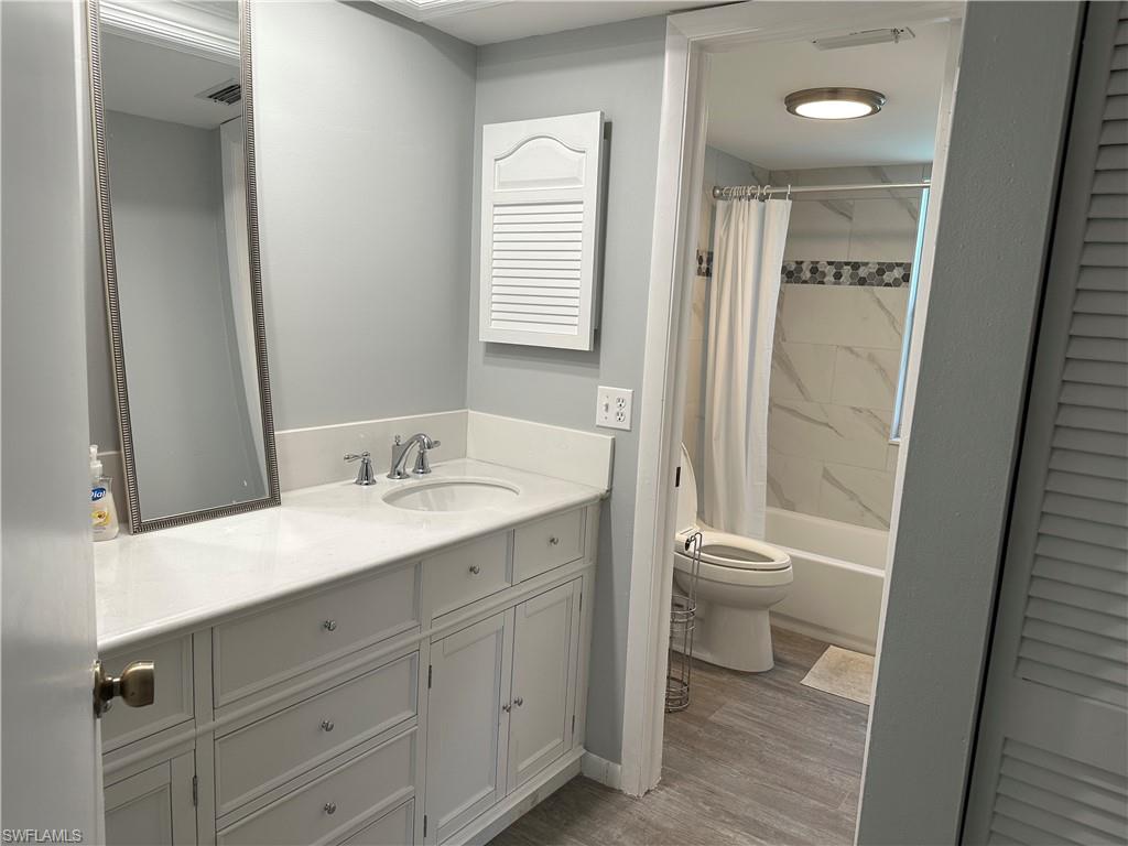 231 Memory Lane, Unit 3 Naples, FL 34112 - Photo 13 of 27 a bathroom with a granite countertop sink toilet and shower