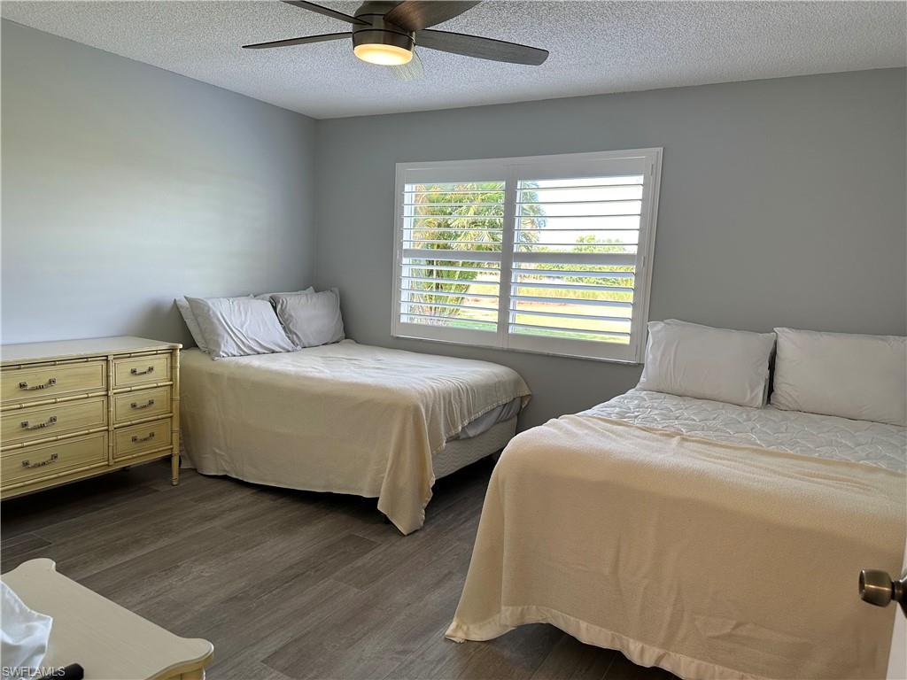 231 Memory Lane, Unit 3 Naples, FL 34112 - Photo 14 of 27 a bedroom with two beds and two dressers