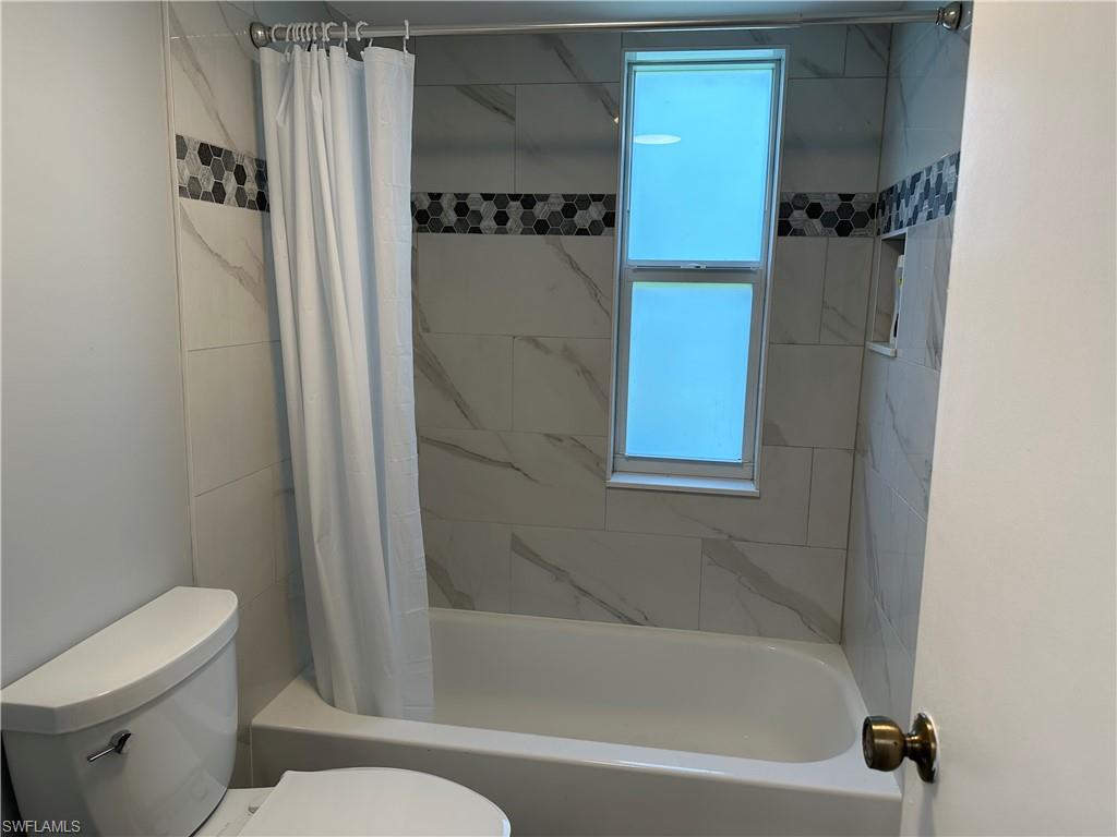 231 Memory Lane, Unit 3 Naples, FL 34112 - Photo 15 of 27 a bathroom with a toilet and a shower