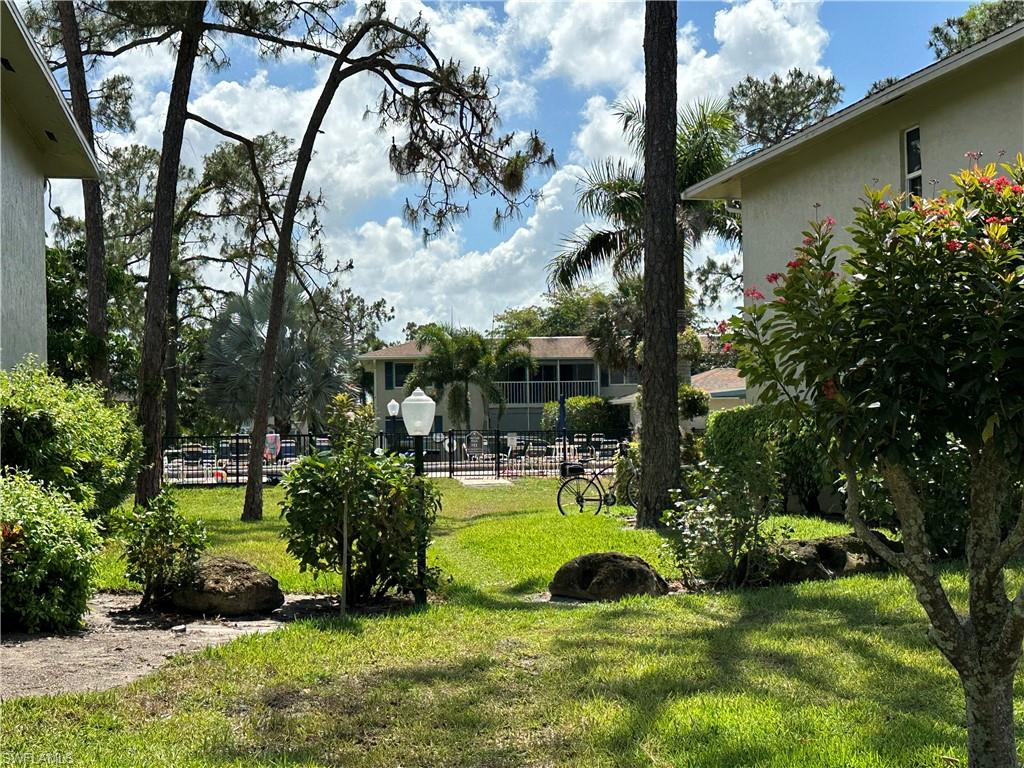 231 Memory Lane, Unit 3 Naples, FL 34112 - Photo 20 of 27 a view of a backyard with swimming pool