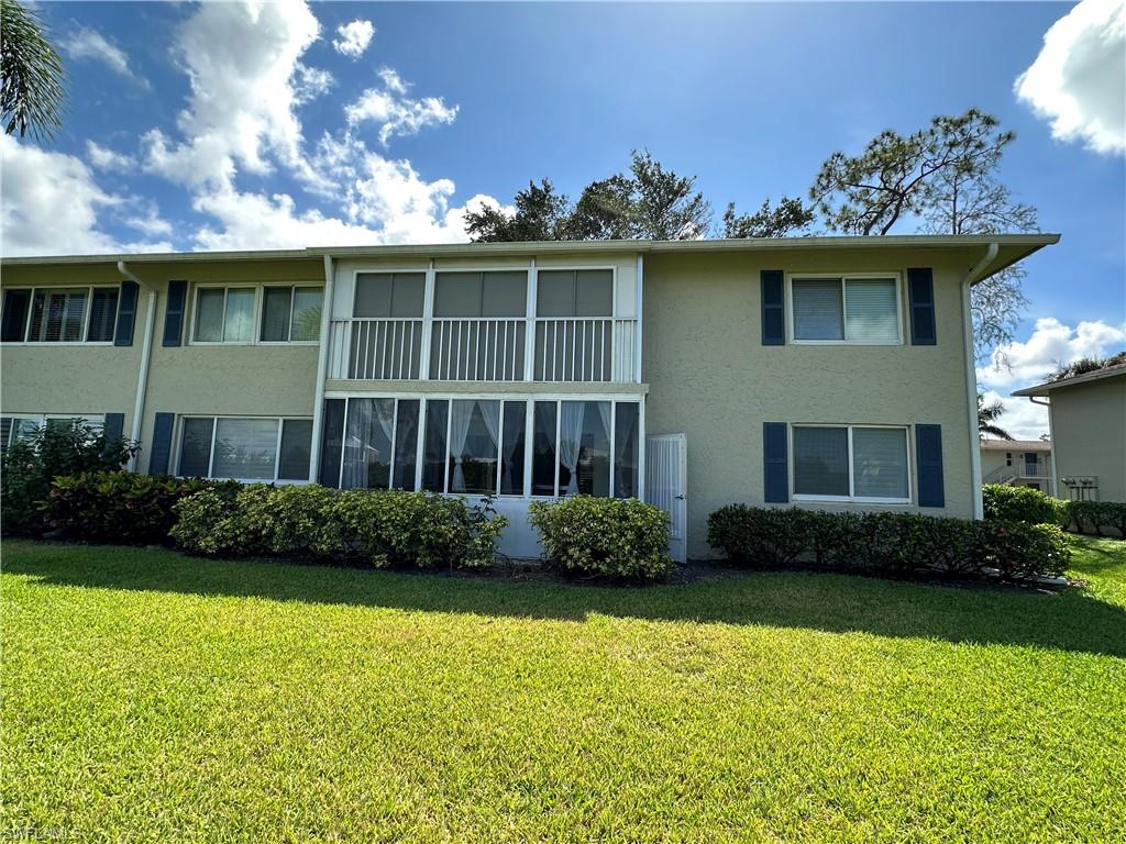 231 Memory Lane, Unit 3 Naples, FL 34112 - Photo 21 of 27 a front view of a house with garden