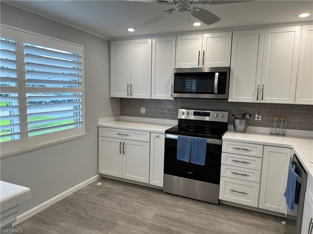 231 Memory Lane, Unit 3 Naples, FL 34112 - Photo 6 of 27 a kitchen with a stove microwave and sink