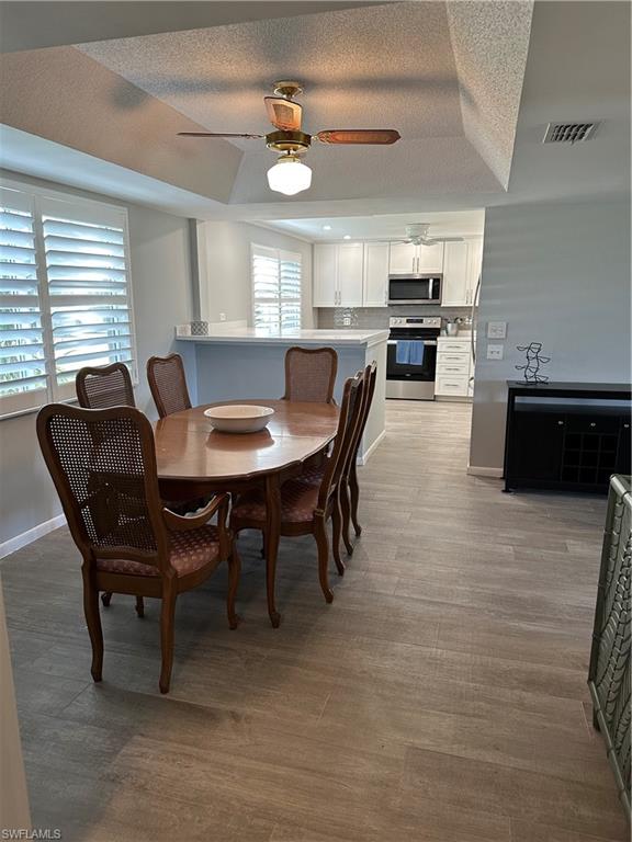 231 Memory Lane, Unit 3 Naples, FL 34112 - Photo 8 of 27 a view of a dining room with furniture and window