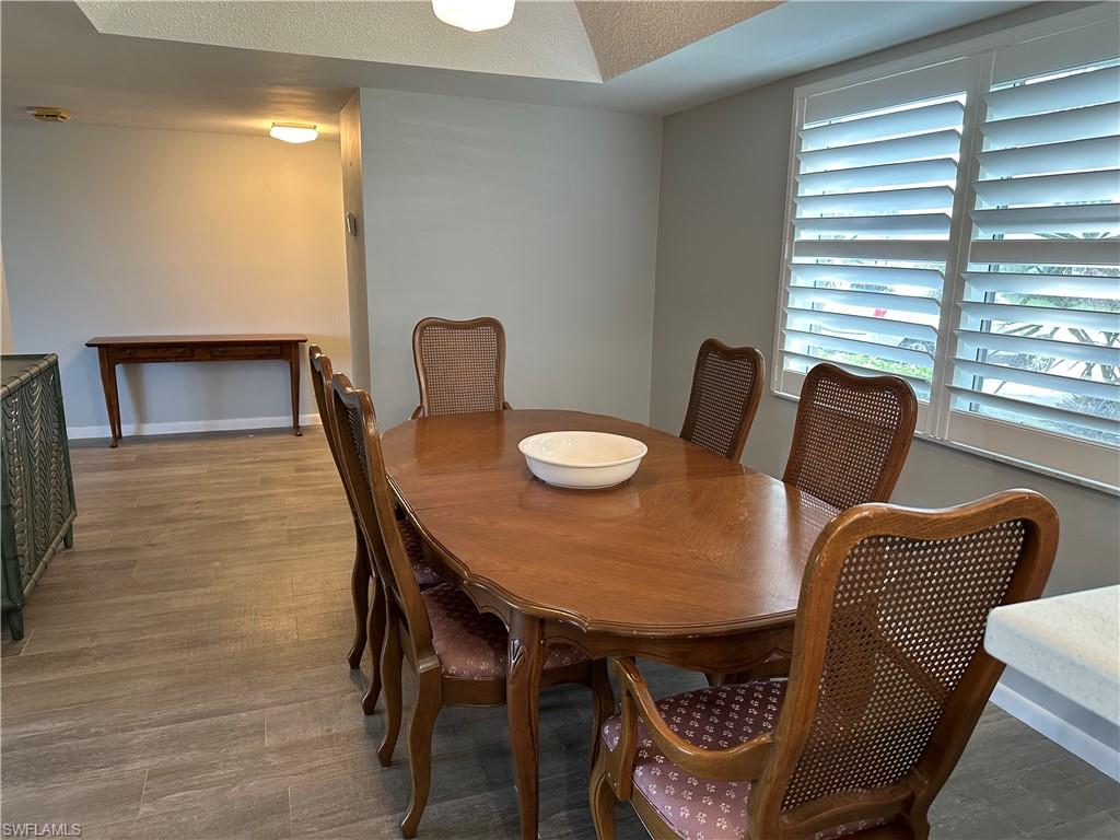 231 Memory Lane, Unit 3 Naples, FL 34112 - Photo 9 of 27 a dining room with furniture and window