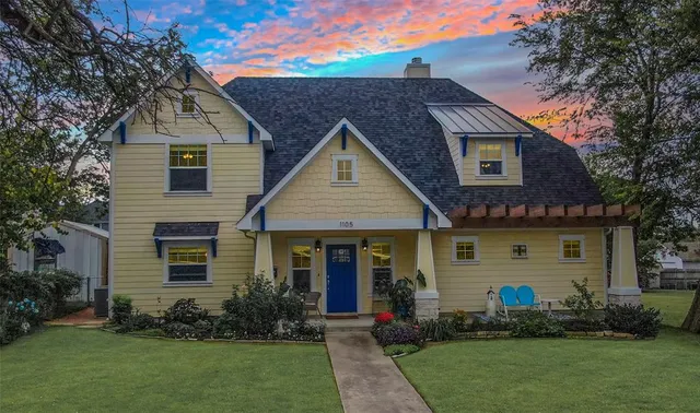 a front view of a house with a garden and plants