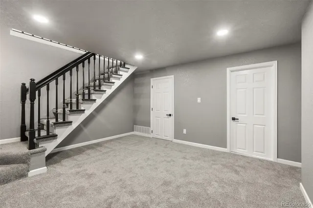 an empty room with a ceiling fan and a window