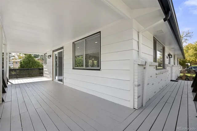 a view of balcony with wooden floor and seating space