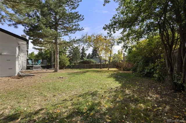 a view of outdoor space with garden and trees