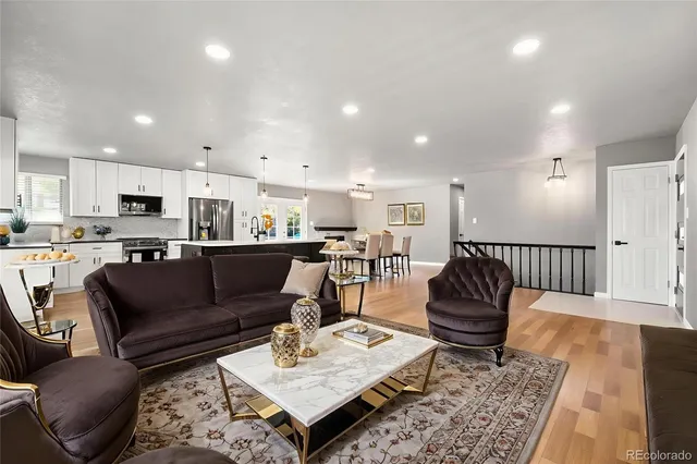 a living room with furniture and kitchen view