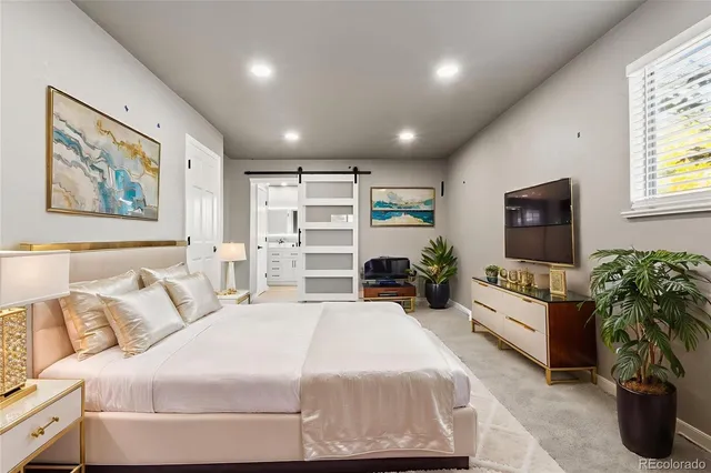 a spacious bedroom with a bed and a couch