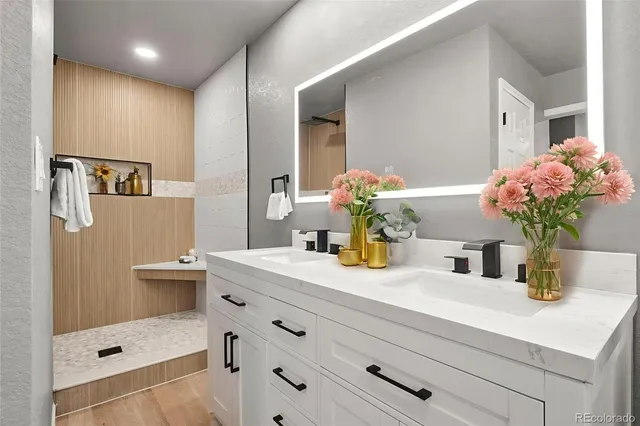 a bathroom with a sink vanity and a mirror