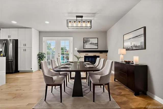 a dining room with furniture a rug and a painting