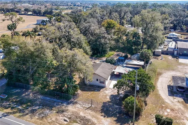 an aerial view of a house with yard and lake view