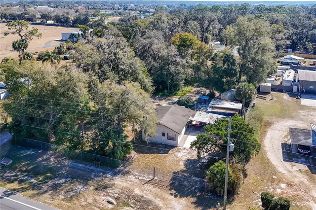 an aerial view of a house with yard and lake view