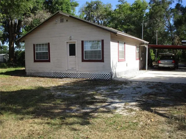 a bedroom with a bed and a curtain