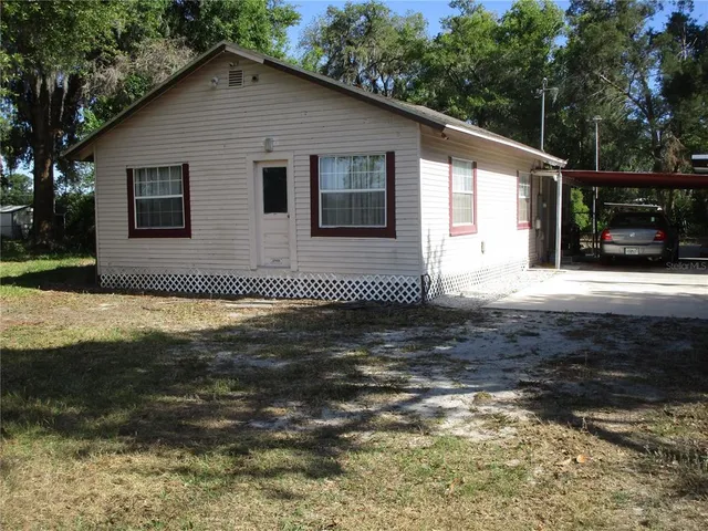 a bedroom with a bed and a curtain