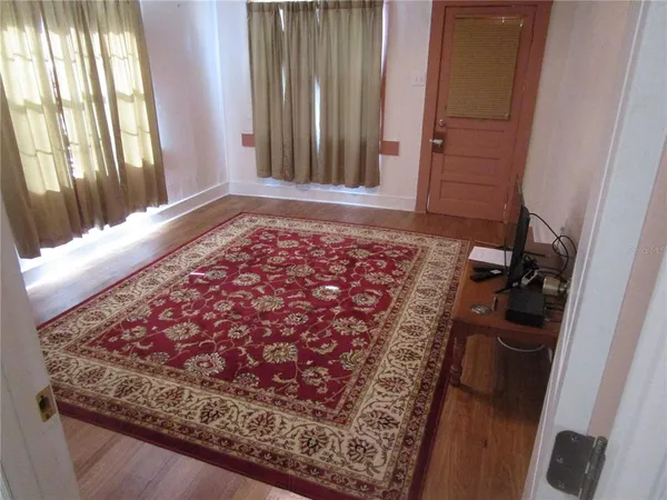 a bed sitting in a bedroom next to a small yard