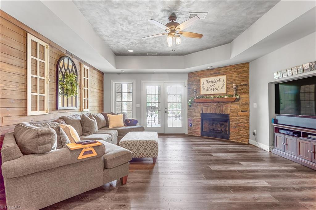 7582 Dubach Road Summerfield, NC 27358 - Photo 27 of 47 Family room in basement with gas fireplace. Doors exit to patio and pool area.