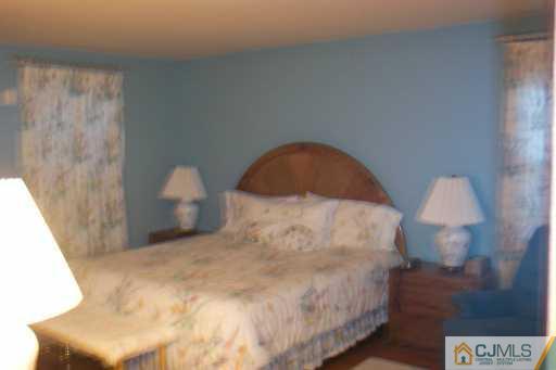 36 Meredith Road Piscataway, NJ 08854 - Photo 8 of 8 a large bed sitting in a bedroom next to a window