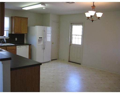 1211 Sacramento Street Portland, TX 78374 - Photo 3 of 5 a kitchen with refrigerator and window