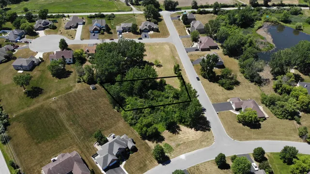 an aerial view of a house with a yard and lake view