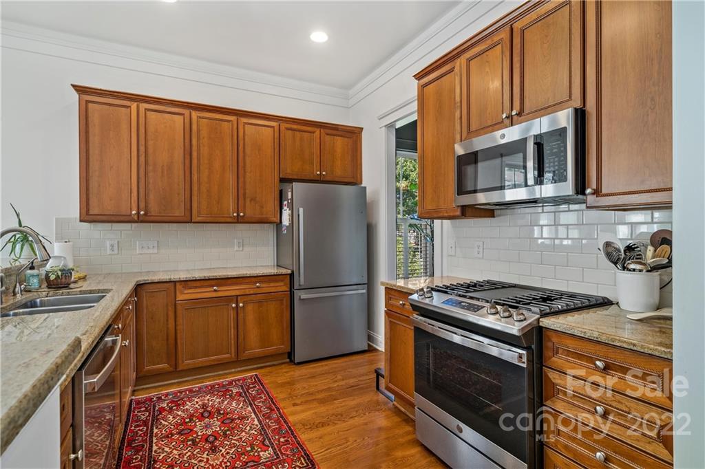 365 Third Baxter Street, Unit 568 Fort Mill, SC 29708 - Photo 12 of 40 a kitchen with stainless steel appliances granite countertop a refrigerator stove and sink