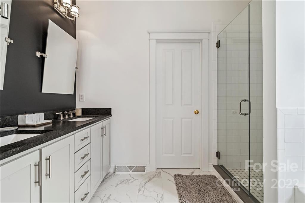 365 Third Baxter Street, Unit 568 Fort Mill, SC 29708 - Photo 23 of 40 a spacious bathroom with a granite countertop sink and a mirror