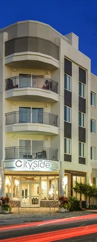 a front view of a house with many windows