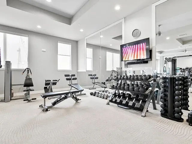 a room with gym equipment and mirrors