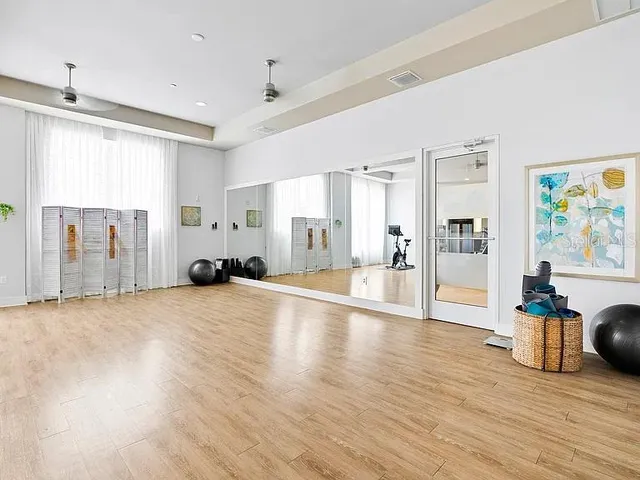 a view of a livingroom with wooden floor and furniture