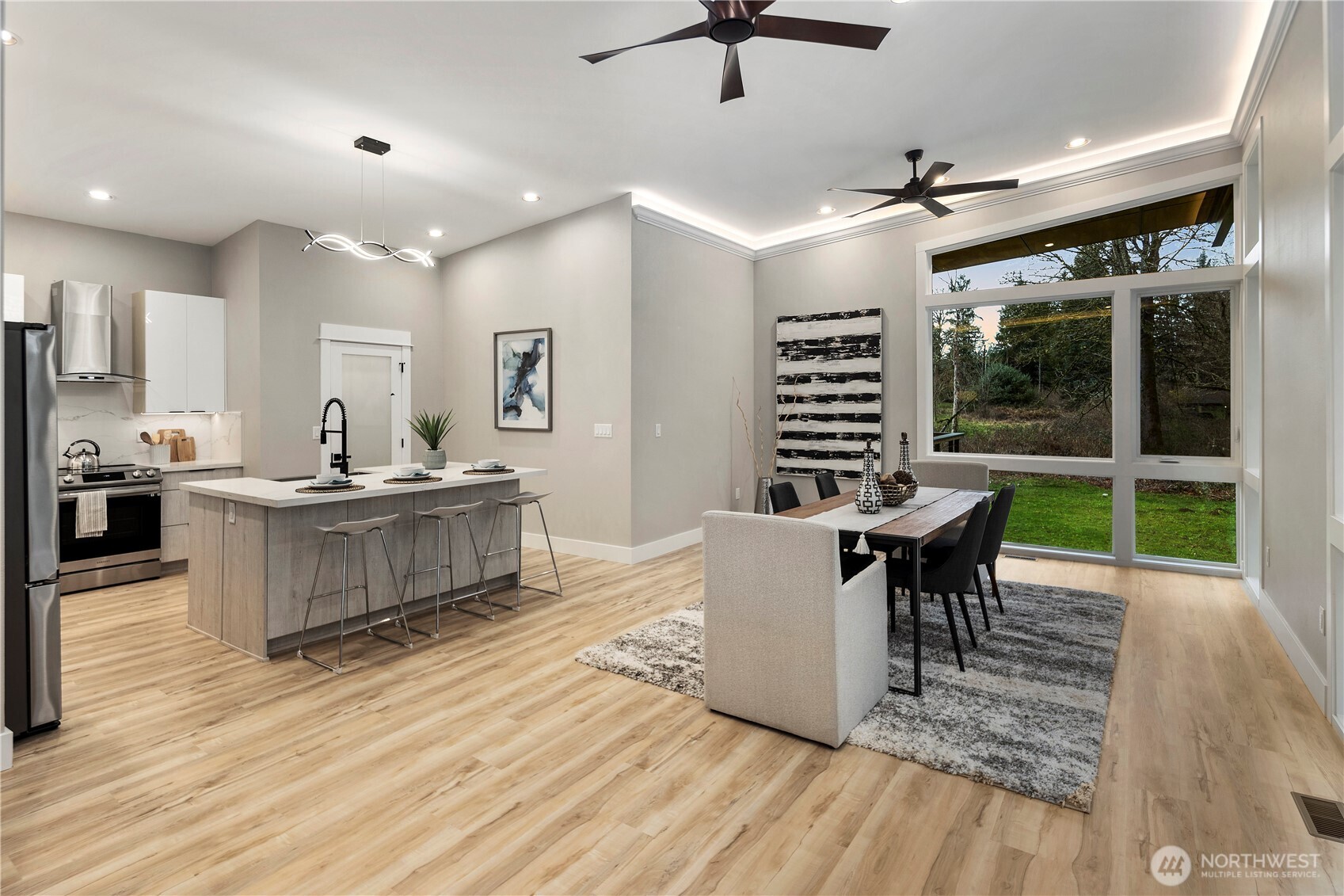 16250 Southeast Lake Moneysmith Road Auburn, WA 98092 - Photo 12 of 40 a living room with furniture a flat screen tv and a floor to ceiling window