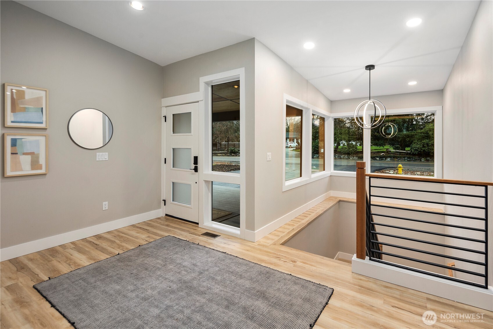 16250 Southeast Lake Moneysmith Road Auburn, WA 98092 - Photo 25 of 40 a view of a hallway with wooden floor and chandelier