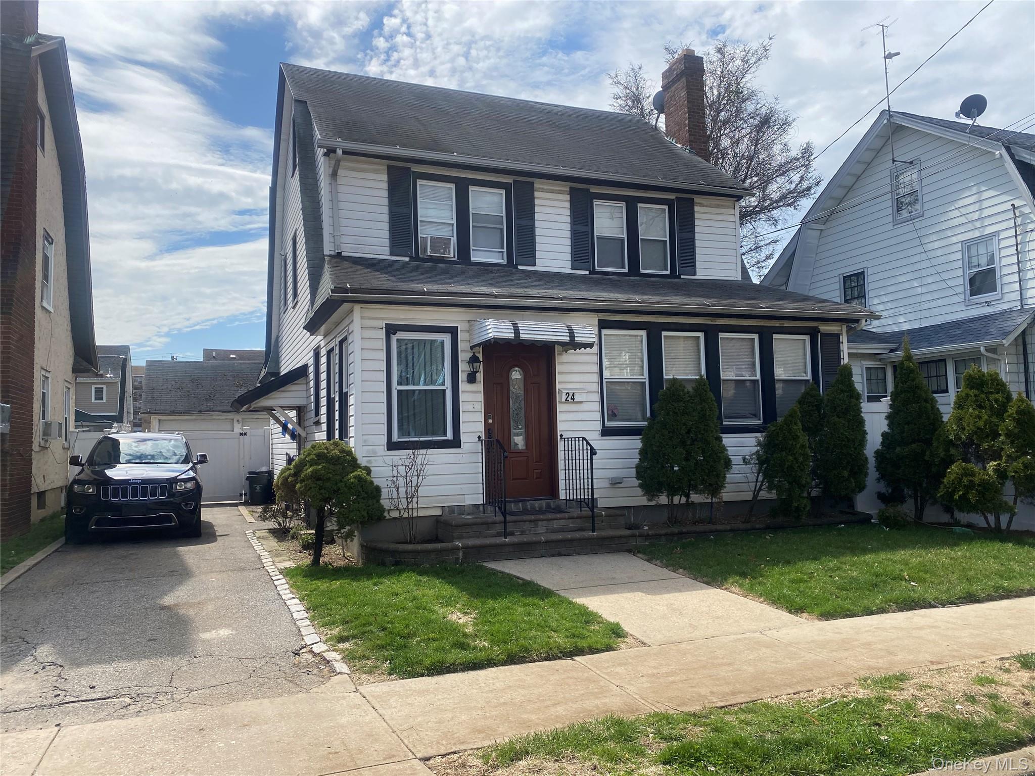 24 Lent Avenue Hempstead, NY 11550 - Photo 1 of 14 a front view of a house with a yard