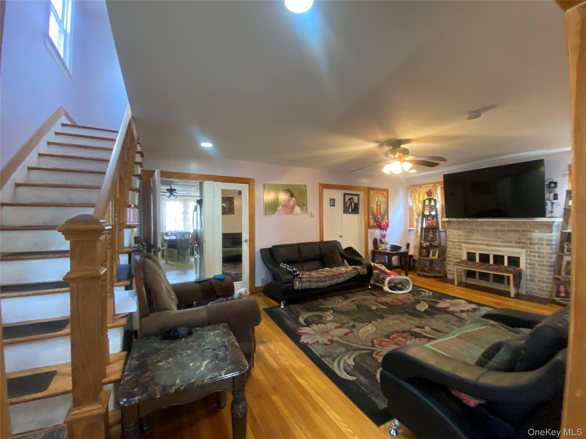 24 Lent Avenue Hempstead, NY 11550 - Photo 3 of 14 a living room with fireplace furniture and a flat screen tv