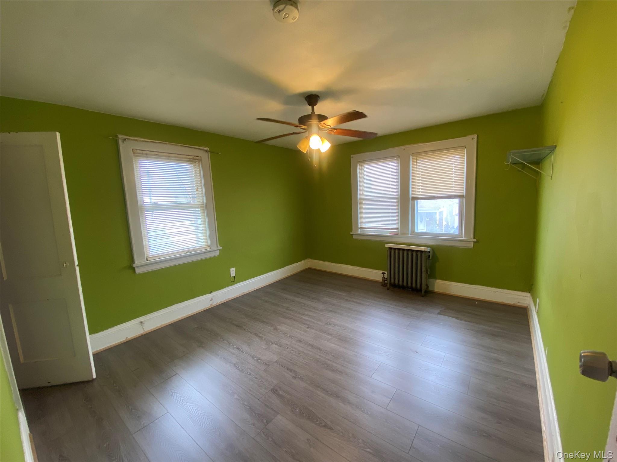 24 Lent Avenue Hempstead, NY 11550 - Photo 9 of 14 a view of an empty room with window and wooden floor