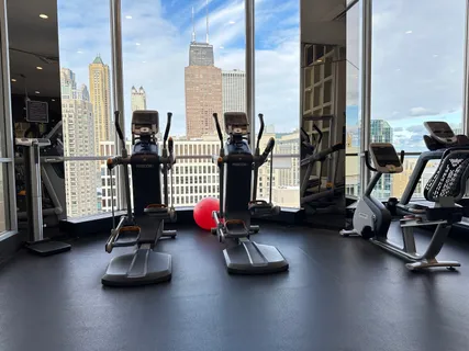 a room with gym equipment and a large window