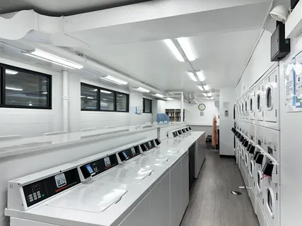 a large white kitchen with stainless steel appliances