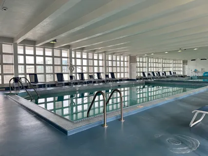 a kitchen with granite countertop a stove a sink and a dining table