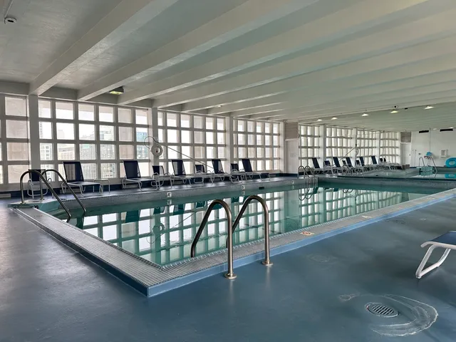 a kitchen with granite countertop a stove a sink and a dining table
