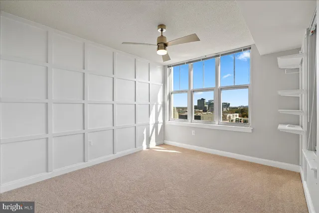 a view of a livingroom with an empty space and a window