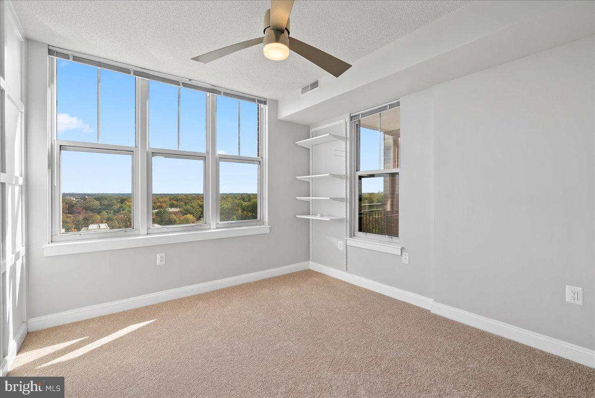 11760 Sunrise Valley Drive, Unit 909 Reston, VA 20191 - Photo 13 of 20 an empty room with a window and ceiling fan